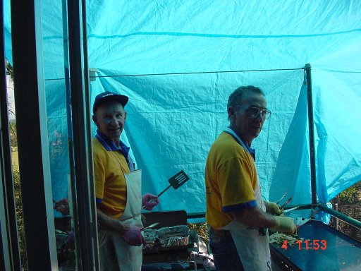 The Chefs working under the cover of the blue tarp